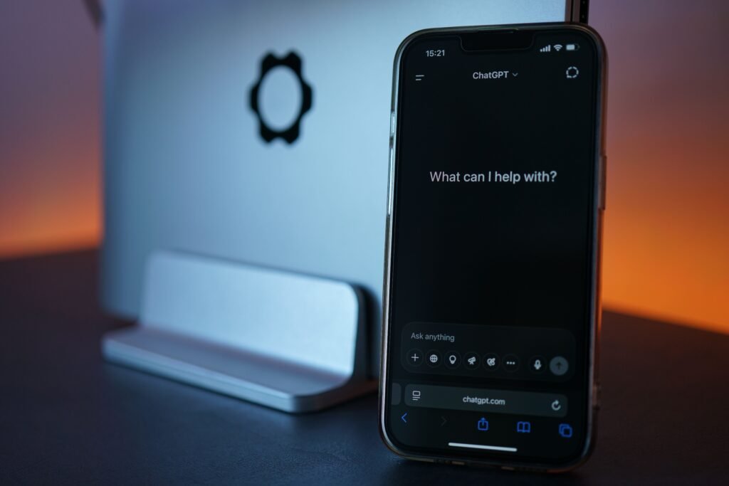 https://www.pexels.com/photo/smartphone-displaying-chat-interface-with-laptop-32021561/